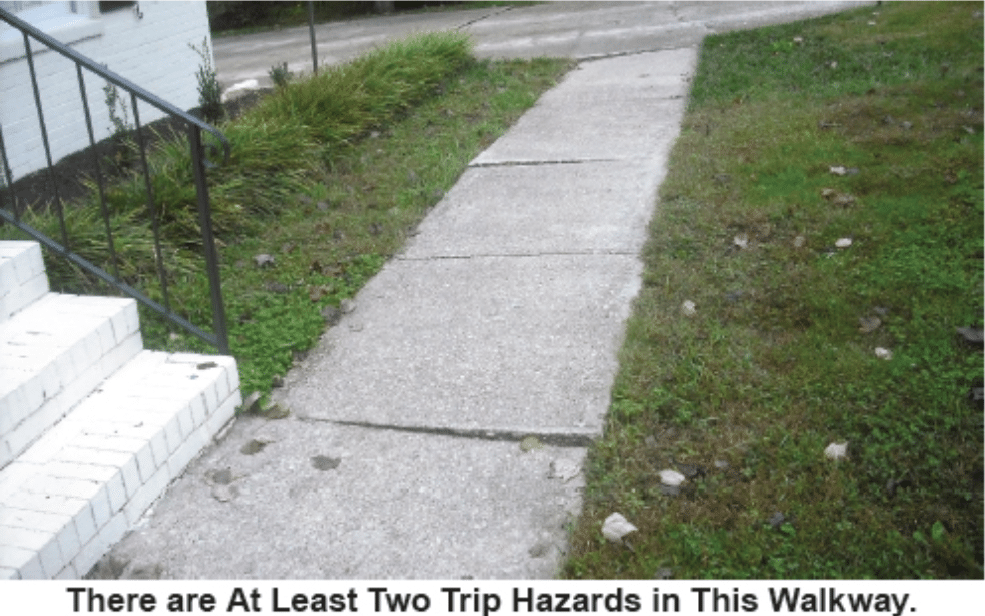 Image displays a walkway with several tripping hazards.
Caption reads "There are At Least Two Trip Hazards in This Walkway."
